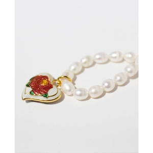 French vintage gold-plated heart enamel rose and pearl necklace on a white background