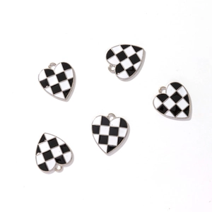 Close-up of five heart-shaped pendants with black and white checkerboard patterns