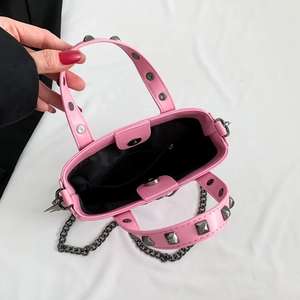 Pink gothic punk crossbody bag with metallic rivets and chain strap, top view interior