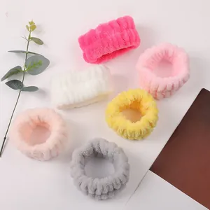 Detailed view of colorful coral fleece wrist washbands with soft plush striped texture