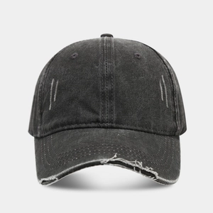 Detail of distressed black washed cotton baseball cap featuring ripped edges and stitching