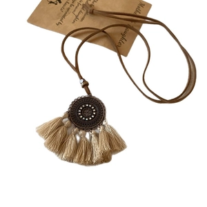 Bohemian geometric necklace with circular pendant, white rhinestones and beige silk tassels