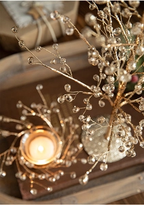 Macro shot of sparkling champagne gold crystal beads on a festive tabletop tree decoration