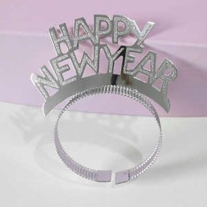 Detail of silver sequined Happy New Year headband on geometric pink and white display