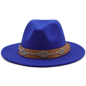 Detail of blue wool felt hat featuring brown leather band with silver ethnic rivets