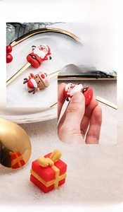 Detail of Christmas spoon showing detachable PVC doll and golden mirror finish texture