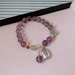 Macro detail of S925 silver amethyst bracelet with engraved Qian Duo Duo charm