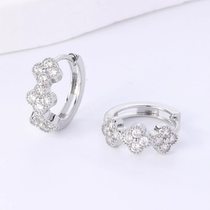 Silver plated clover hoop earrings with cubic zirconia stones in a floral design
