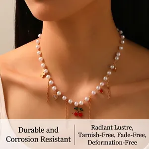 Detail showing pearl necklace with cherry pendant and butterfly fringe on a model