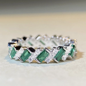 Elegant S925 sterling silver ring with emerald cut stones and diamonds in a wavy band