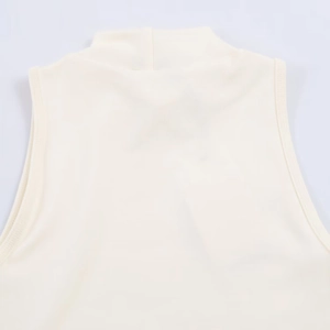 Detail of the high neckline and stitching on this cream sleeveless elastic top