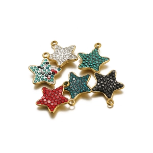 Macro detail of star-shaped pendants with gold plating and colorful pavé crystals