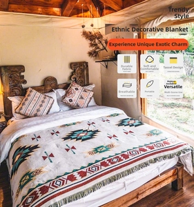 Detail of bohemian cotton blanket with ethnic texture and fringe edge for home decor
