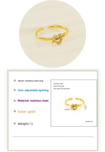 Detail of adjustable 18K gold plated heart and arrow ring with sparkling white rhinestones