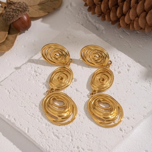 Vintage 18K gold plated stainless steel spiral tassel earrings on white stone slab