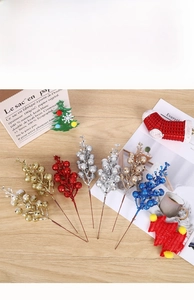 Close-up of sparkling glitter berry picks for Christmas tree and festive DIY decoration