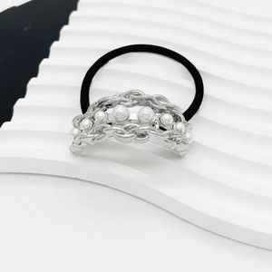 Close-up of black elastic hair tie with silver alloy chain and inlaid white pearls