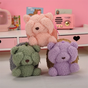 Detailed shot of cute teddy bear plush coin purses in pink, green, and purple fuzzy fabric