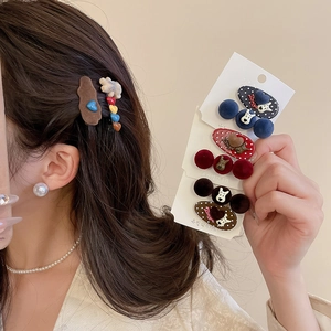 Detailed view of flocked polka dot hair clips and cartoon heart clips in a 2-piece set