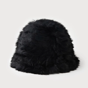Close-up of thick black faux rabbit fur texture on a warm winter bucket hat for women