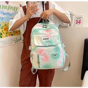 Front view of gradient mint and pink backpack with moon and butterfly prints