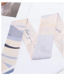 Macro shot of geometric print silk scarf with abstract blue blocks and script design