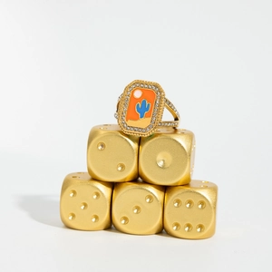 Detail of gold octagonal ring with enamel desert scene and pavé crystal setting