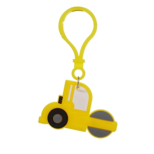 Detail of yellow soft PVC tractor keychain with grey wheels and white windows