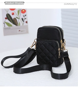 Detailed view of black quilted nylon phone bag with gold zipper and adjustable strap