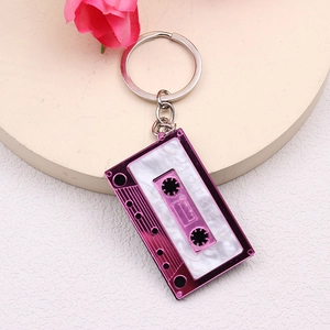 Pink cassette tape keychain with white marbled resin inlay and metal frame for women