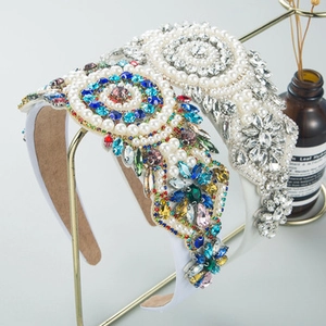 Baroque floral headbands with colorful rhinestones and pearls on gold display stand