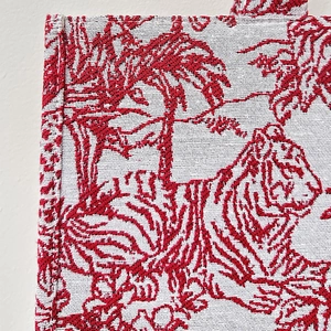 Detail of red and white Toile de Jouy tiger embroidery on a premium woven tote bag