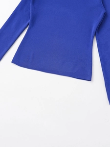 Close-up of royal blue ribbed knit texture and hemline of the long sleeve top
