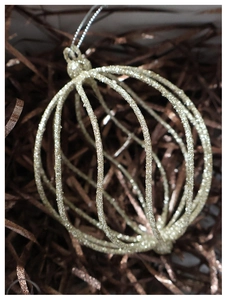 Macro shot of champagne gold hollow vertical rib Christmas ball ornament with glitter texture