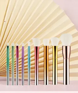 Detail of 9-piece makeup brush set with colorful metallic handles and white soft bristles