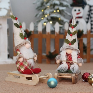 Christmas gnome couple sitting on wooden sleds for festive holiday home decorations