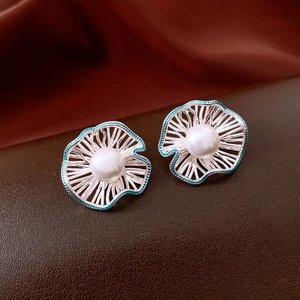 Detailed view of silver fan-shaped hollow flower earrings with blue oil drip and white pearl