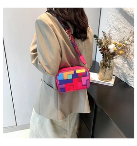 Detail of colorful geometric patchwork crossbody bag with patterned wide strap