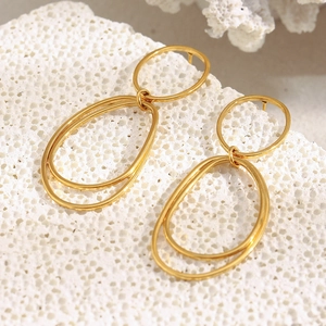 Minimalist 18K gold plated stainless steel interlocking oval hoop earrings on coral