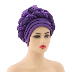 Close-up of purple turban hat with sparkling sequin braid detail on soft fabric