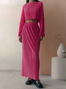 Elegant rose red pleated two-piece set featuring long sleeve crop top and high waist maxi skirt