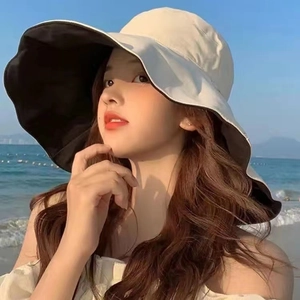 Close-up of wide brim sun hat with double-sided cream and black fabric for women