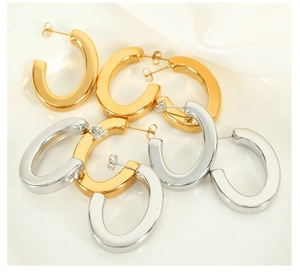 Polished gold and silver thick U-shaped hoop earrings stacked on white background