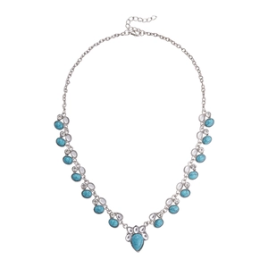 Bohemian silver necklace with turquoise stone, moon and star charms on white background