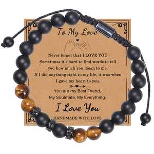 Close-up of beaded tiger eye and matte stone bracelet with sentimental gift card