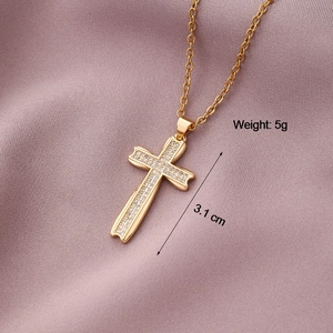 Detailed close-up of gold cross pendant with cubic zirconia, length 3.1cm, weight 5g