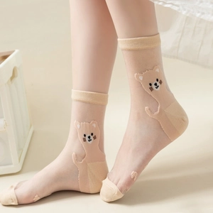 Detailed view of sheer mesh mid-calf socks featuring a cute cartoon bear pattern