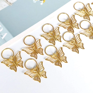 Close-up of golden hollow butterfly hair rings for DIY braiding and hair styling accessories