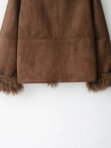 Close-up detail of brown suede jacket hem and cuffs with plush faux fur trim textures