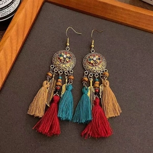 Bohemian ethnic long tassel earrings with bronze floral disks and colorful feathers